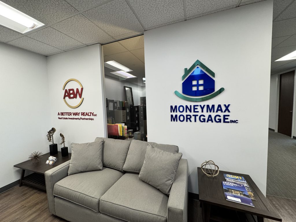 MoneyMax Mortgage and A Better Way Realty signs above a shared reception seating area
