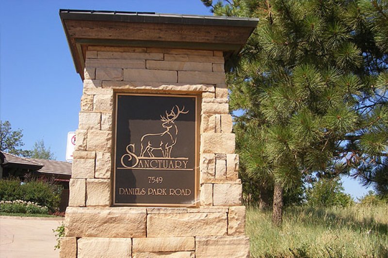 Sanctuary Golf Course cast bronze plaque integrated into a stone entrance monument